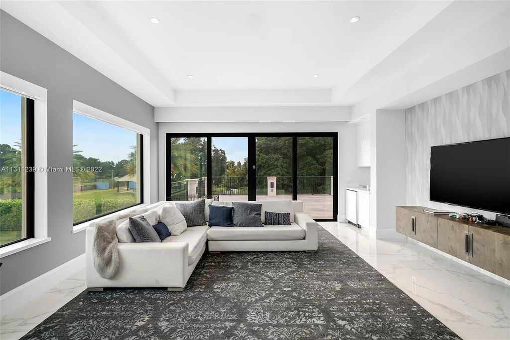 5875 Stone Creek Way, Fort Lauderdale, Florida, built by acclaimed builder Rick Bell, sits on 5 acres and boasts over 20,000 square feet of space. This incredible and one-of-a-kind custom compound's grand estate, including private gates, features volume ceilings, a resort-style pool, and top-of-the-line appliances.