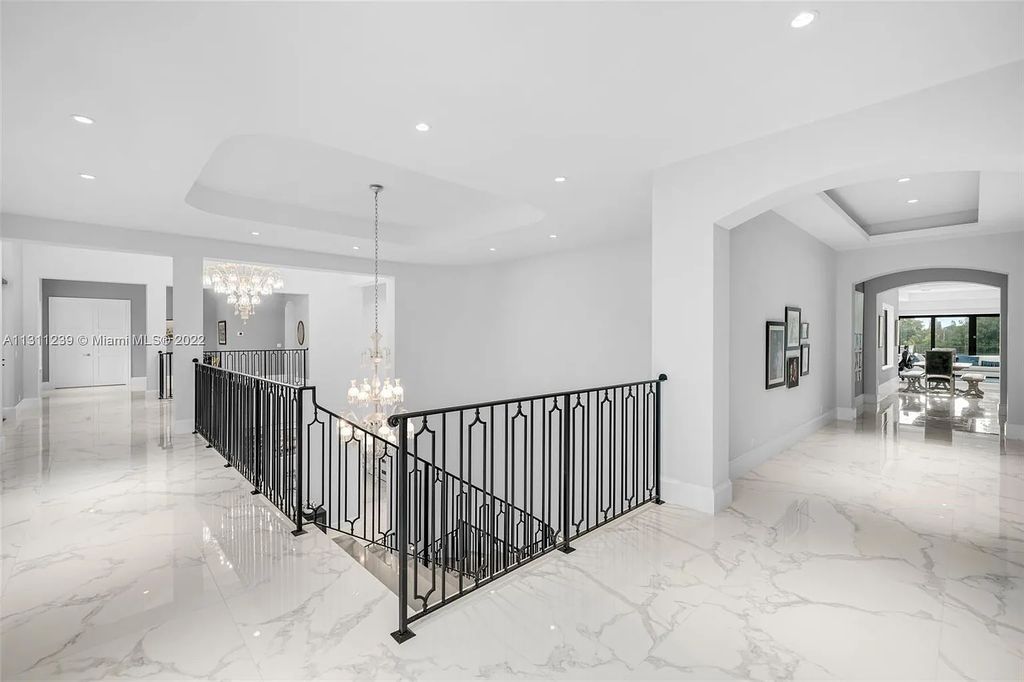 5875 Stone Creek Way, Fort Lauderdale, Florida, built by acclaimed builder Rick Bell, sits on 5 acres and boasts over 20,000 square feet of space. This incredible and one-of-a-kind custom compound's grand estate, including private gates, features volume ceilings, a resort-style pool, and top-of-the-line appliances.
