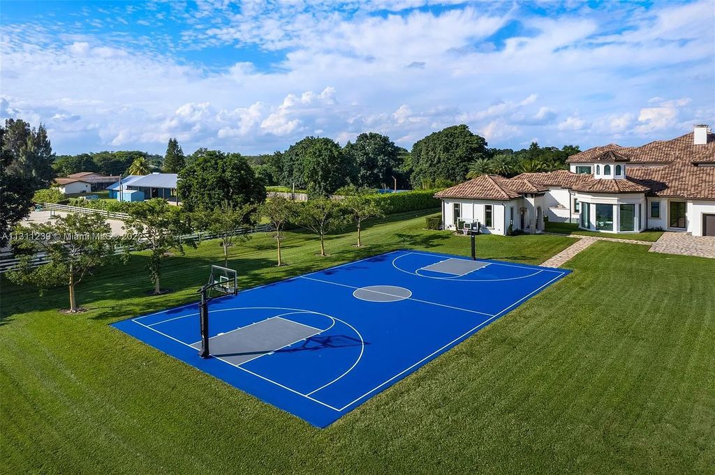 5875 Stone Creek Way, Fort Lauderdale, Florida, built by acclaimed builder Rick Bell, sits on 5 acres and boasts over 20,000 square feet of space. This incredible and one-of-a-kind custom compound's grand estate, including private gates, features volume ceilings, a resort-style pool, and top-of-the-line appliances.