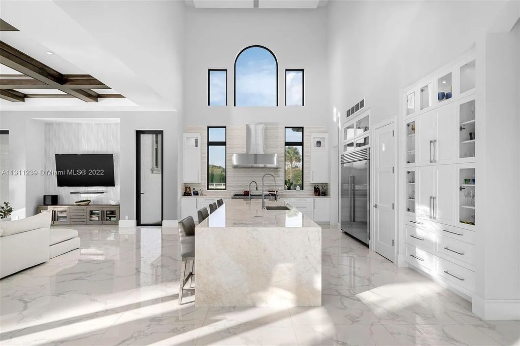 5875 Stone Creek Way, Fort Lauderdale, Florida, built by acclaimed builder Rick Bell, sits on 5 acres and boasts over 20,000 square feet of space. This incredible and one-of-a-kind custom compound's grand estate, including private gates, features volume ceilings, a resort-style pool, and top-of-the-line appliances.