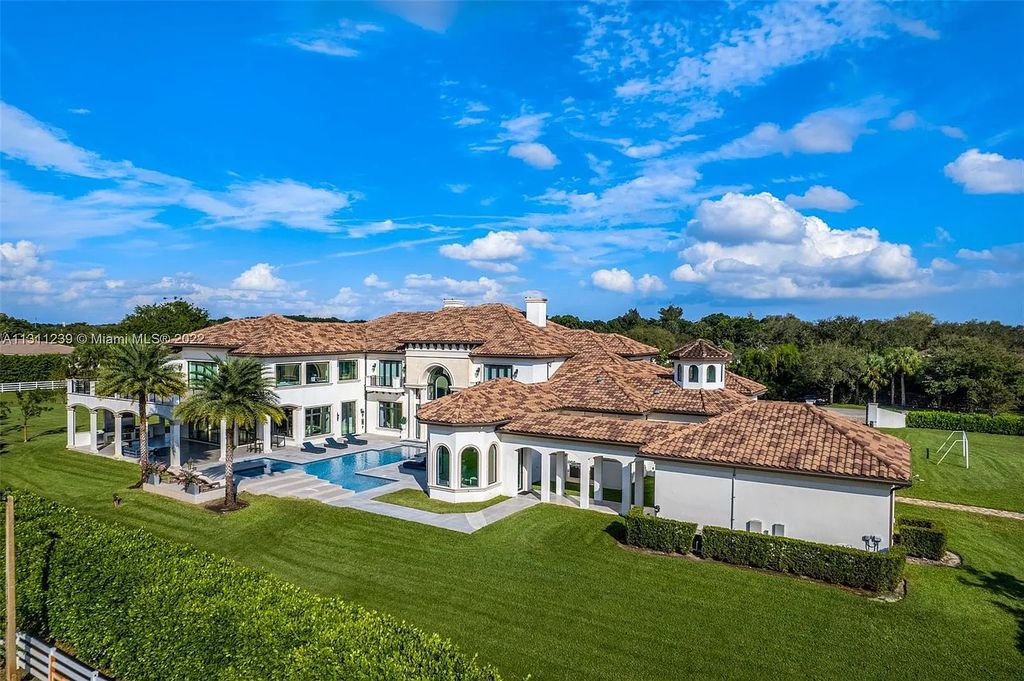 5875 Stone Creek Way, Fort Lauderdale, Florida, built by acclaimed builder Rick Bell, sits on 5 acres and boasts over 20,000 square feet of space. This incredible and one-of-a-kind custom compound's grand estate, including private gates, features volume ceilings, a resort-style pool, and top-of-the-line appliances.