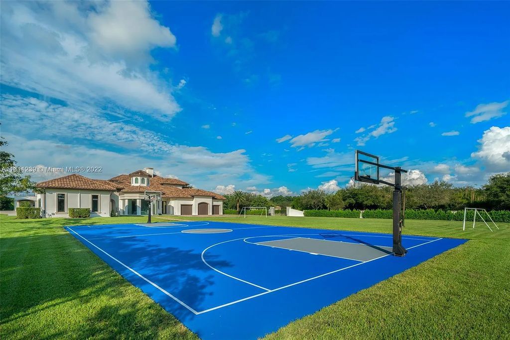 5875 Stone Creek Way, Fort Lauderdale, Florida, built by acclaimed builder Rick Bell, sits on 5 acres and boasts over 20,000 square feet of space. This incredible and one-of-a-kind custom compound's grand estate, including private gates, features volume ceilings, a resort-style pool, and top-of-the-line appliances.