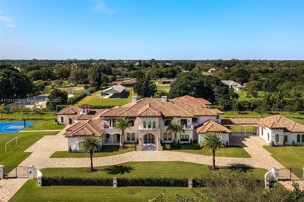5875 Stone Creek Way, Fort Lauderdale, Florida, built by acclaimed builder Rick Bell, sits on 5 acres and boasts over 20,000 square feet of space. This incredible and one-of-a-kind custom compound's grand estate, including private gates, features volume ceilings, a resort-style pool, and top-of-the-line appliances.