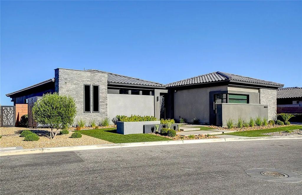 11296 Villa Bellagio Drive, Las Vegas, Nevada is a stunning modern home situated on an elevated lot within the highly sought after Bluffs at Tuscan Cliffs Southern Highlands guard gated community with breathtaking city, mountain and strip views.