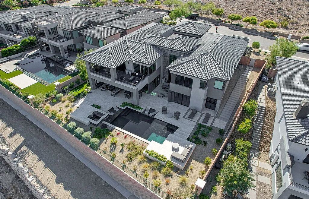 11296 Villa Bellagio Drive, Las Vegas, Nevada is a stunning modern home situated on an elevated lot within the highly sought after Bluffs at Tuscan Cliffs Southern Highlands guard gated community with breathtaking city, mountain and strip views.
