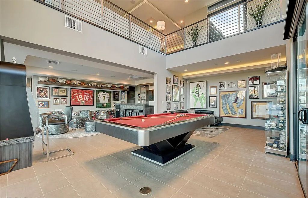 11296 Villa Bellagio Drive, Las Vegas, Nevada is a stunning modern home situated on an elevated lot within the highly sought after Bluffs at Tuscan Cliffs Southern Highlands guard gated community with breathtaking city, mountain and strip views.