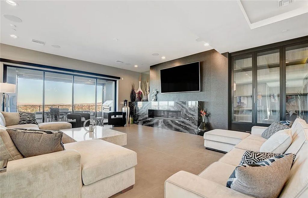 11296 Villa Bellagio Drive, Las Vegas, Nevada is a stunning modern home situated on an elevated lot within the highly sought after Bluffs at Tuscan Cliffs Southern Highlands guard gated community with breathtaking city, mountain and strip views.