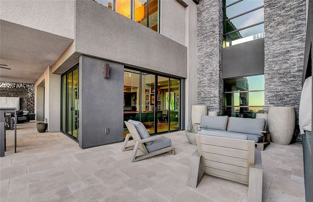 11296 Villa Bellagio Drive, Las Vegas, Nevada is a stunning modern home situated on an elevated lot within the highly sought after Bluffs at Tuscan Cliffs Southern Highlands guard gated community with breathtaking city, mountain and strip views.