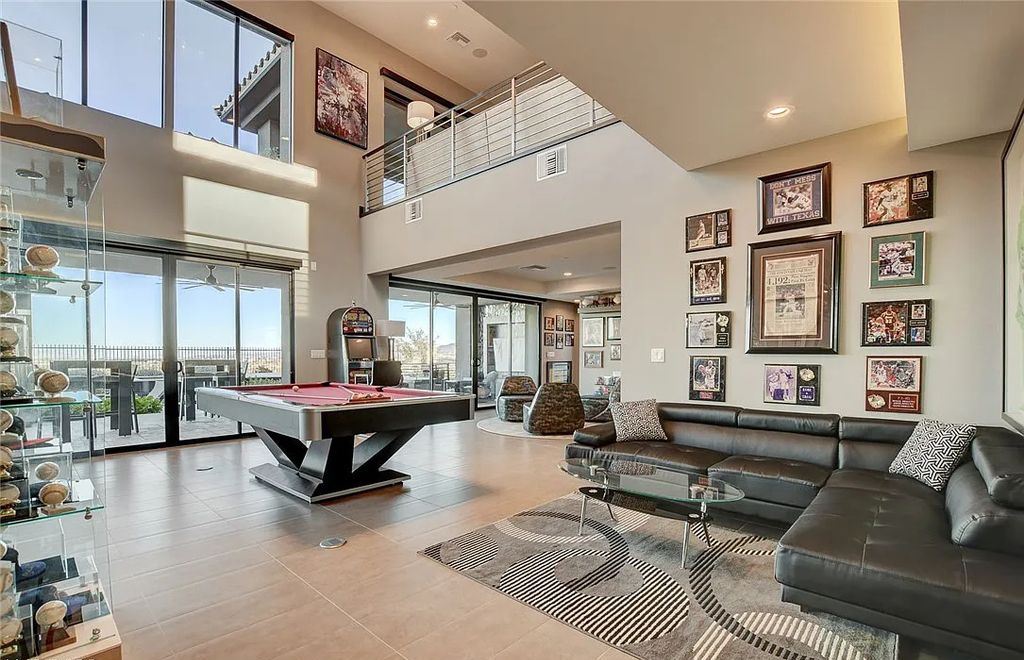 11296 Villa Bellagio Drive, Las Vegas, Nevada is a stunning modern home situated on an elevated lot within the highly sought after Bluffs at Tuscan Cliffs Southern Highlands guard gated community with breathtaking city, mountain and strip views.