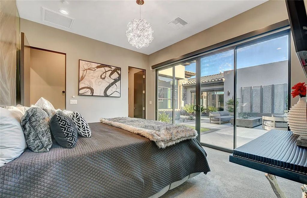 11296 Villa Bellagio Drive, Las Vegas, Nevada is a stunning modern home situated on an elevated lot within the highly sought after Bluffs at Tuscan Cliffs Southern Highlands guard gated community with breathtaking city, mountain and strip views.