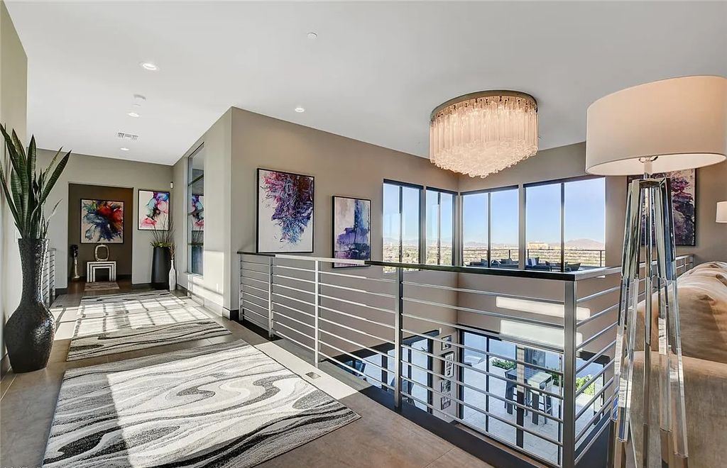 11296 Villa Bellagio Drive, Las Vegas, Nevada is a stunning modern home situated on an elevated lot within the highly sought after Bluffs at Tuscan Cliffs Southern Highlands guard gated community with breathtaking city, mountain and strip views.