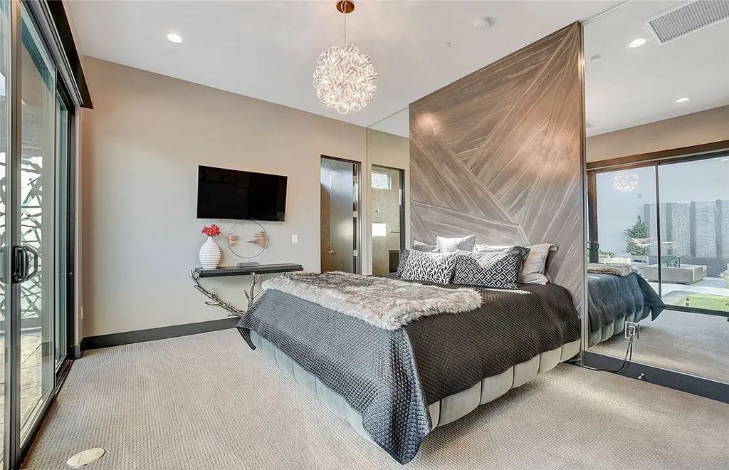 11296 Villa Bellagio Drive, Las Vegas, Nevada is a stunning modern home situated on an elevated lot within the highly sought after Bluffs at Tuscan Cliffs Southern Highlands guard gated community with breathtaking city, mountain and strip views.