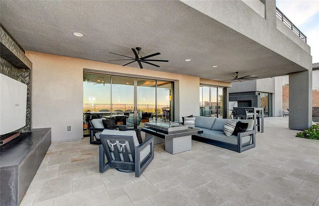 11296 Villa Bellagio Drive, Las Vegas, Nevada is a stunning modern home situated on an elevated lot within the highly sought after Bluffs at Tuscan Cliffs Southern Highlands guard gated community with breathtaking city, mountain and strip views.