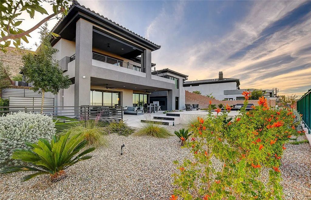 11296 Villa Bellagio Drive, Las Vegas, Nevada is a stunning modern home situated on an elevated lot within the highly sought after Bluffs at Tuscan Cliffs Southern Highlands guard gated community with breathtaking city, mountain and strip views.