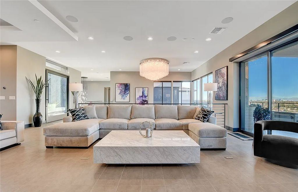 11296 Villa Bellagio Drive, Las Vegas, Nevada is a stunning modern home situated on an elevated lot within the highly sought after Bluffs at Tuscan Cliffs Southern Highlands guard gated community with breathtaking city, mountain and strip views.