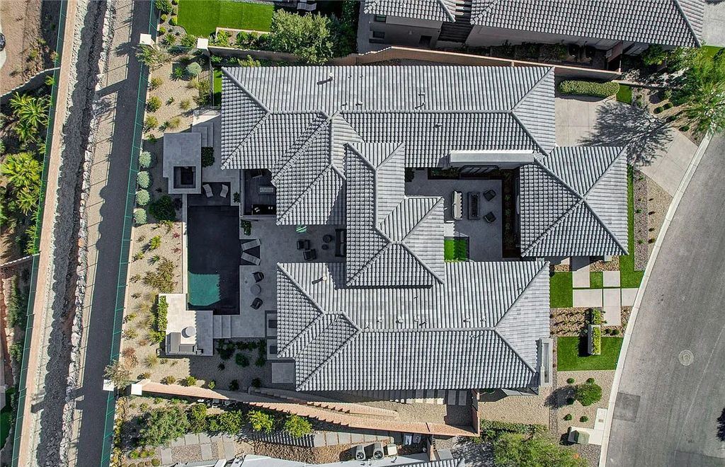 11296 Villa Bellagio Drive, Las Vegas, Nevada is a stunning modern home situated on an elevated lot within the highly sought after Bluffs at Tuscan Cliffs Southern Highlands guard gated community with breathtaking city, mountain and strip views.