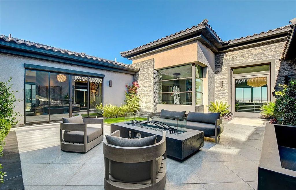 11296 Villa Bellagio Drive, Las Vegas, Nevada is a stunning modern home situated on an elevated lot within the highly sought after Bluffs at Tuscan Cliffs Southern Highlands guard gated community with breathtaking city, mountain and strip views.