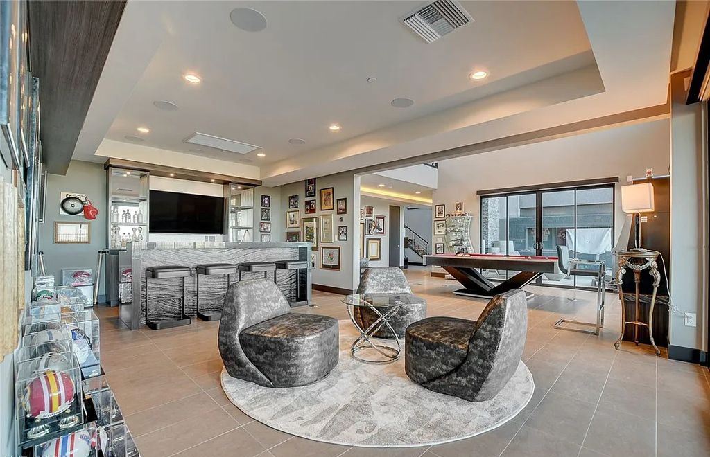 11296 Villa Bellagio Drive, Las Vegas, Nevada is a stunning modern home situated on an elevated lot within the highly sought after Bluffs at Tuscan Cliffs Southern Highlands guard gated community with breathtaking city, mountain and strip views.