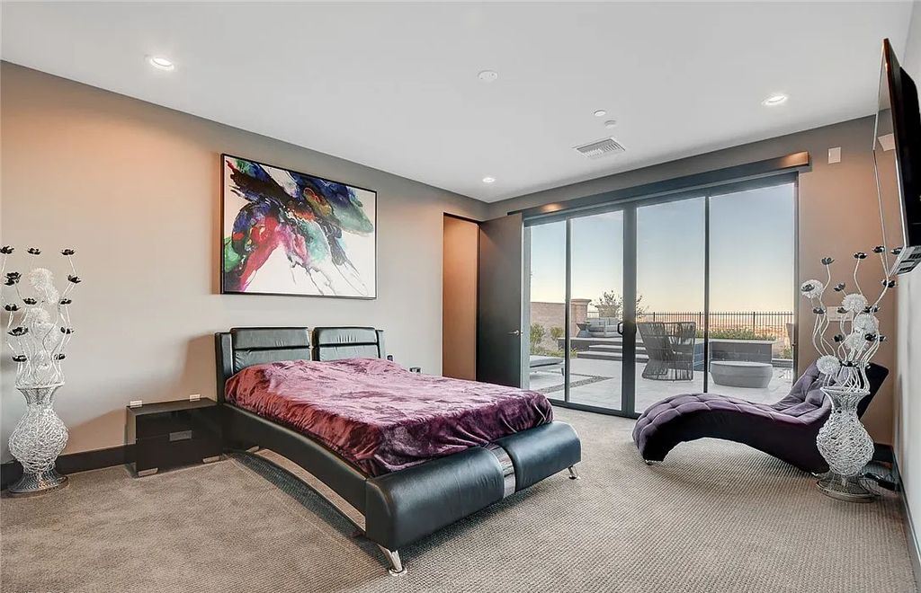 11296 Villa Bellagio Drive, Las Vegas, Nevada is a stunning modern home situated on an elevated lot within the highly sought after Bluffs at Tuscan Cliffs Southern Highlands guard gated community with breathtaking city, mountain and strip views.
