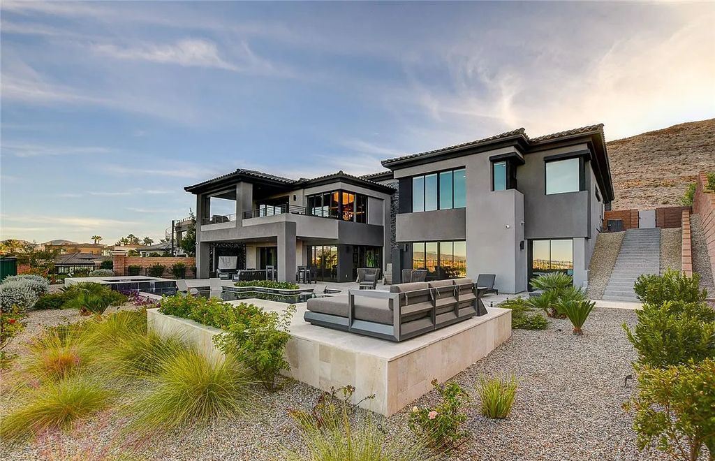 11296 Villa Bellagio Drive, Las Vegas, Nevada is a stunning modern home situated on an elevated lot within the highly sought after Bluffs at Tuscan Cliffs Southern Highlands guard gated community with breathtaking city, mountain and strip views.