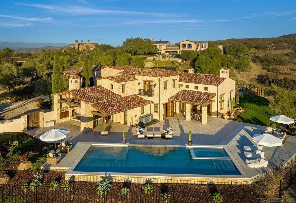 8069 Entrada De Luz East, San Diego, California is an exquisite estate located on in one of the most exclusive, gated golf communities in San Diego, boasts total privacy, large living areas, open through disappearing doors to multiple covered patios.