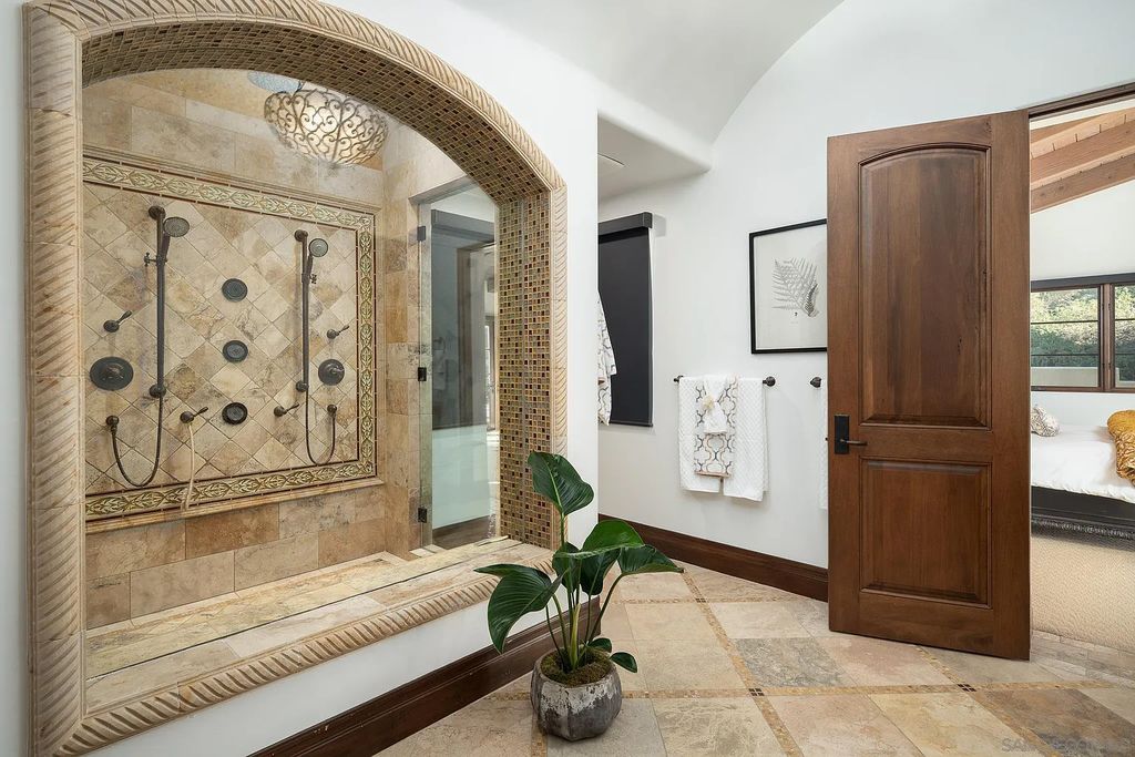 8069 Entrada De Luz East, San Diego, California is an exquisite estate located on in one of the most exclusive, gated golf communities in San Diego, boasts total privacy, large living areas, open through disappearing doors to multiple covered patios.