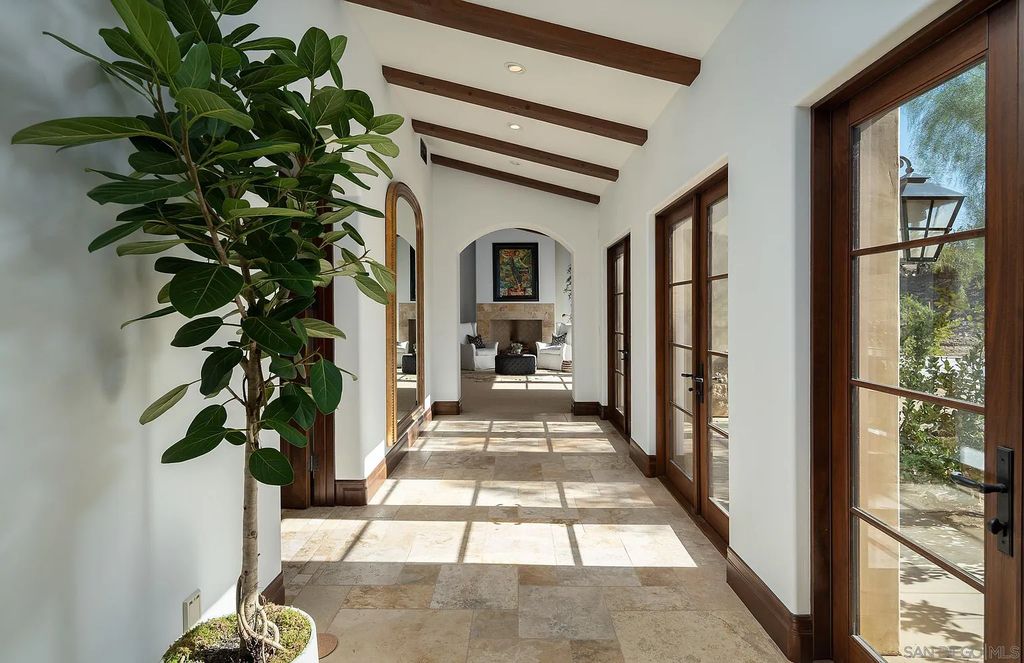 8069 Entrada De Luz East, San Diego, California is an exquisite estate located on in one of the most exclusive, gated golf communities in San Diego, boasts total privacy, large living areas, open through disappearing doors to multiple covered patios.