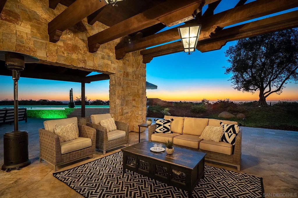 8069 Entrada De Luz East, San Diego, California is an exquisite estate located on in one of the most exclusive, gated golf communities in San Diego, boasts total privacy, large living areas, open through disappearing doors to multiple covered patios.