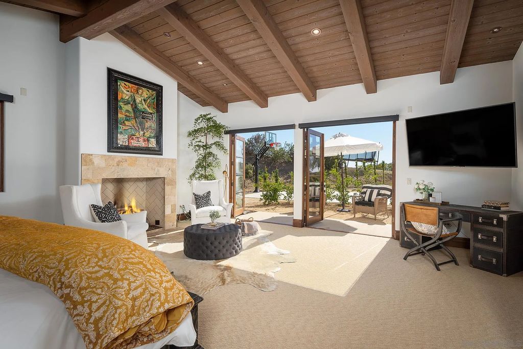 8069 Entrada De Luz East, San Diego, California is an exquisite estate located on in one of the most exclusive, gated golf communities in San Diego, boasts total privacy, large living areas, open through disappearing doors to multiple covered patios.