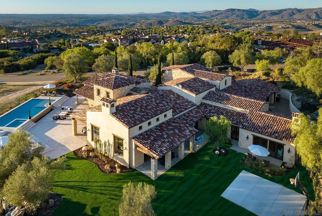 8069 Entrada De Luz East, San Diego, California is an exquisite estate located on in one of the most exclusive, gated golf communities in San Diego, boasts total privacy, large living areas, open through disappearing doors to multiple covered patios.