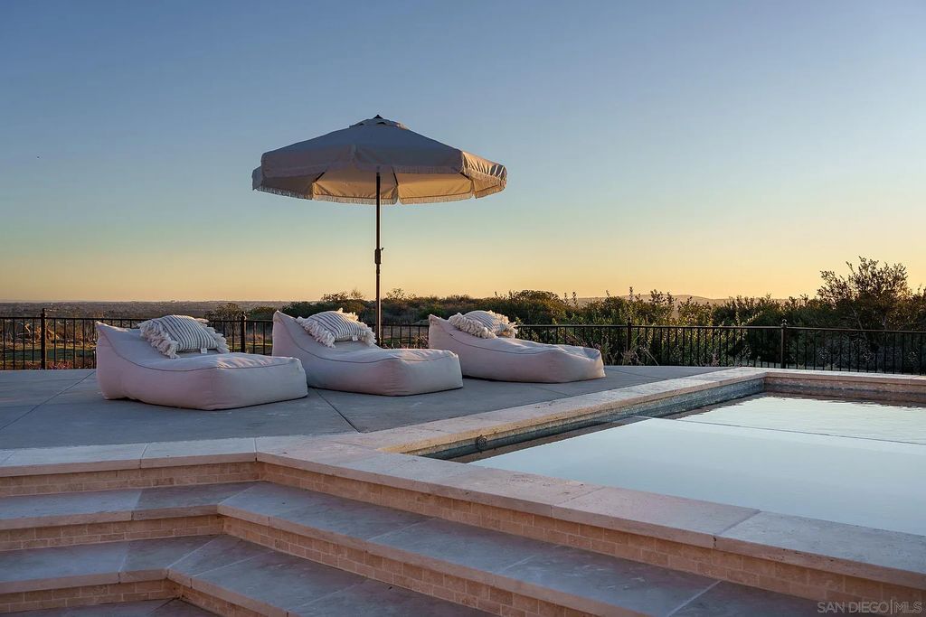 8069 Entrada De Luz East, San Diego, California is an exquisite estate located on in one of the most exclusive, gated golf communities in San Diego, boasts total privacy, large living areas, open through disappearing doors to multiple covered patios.