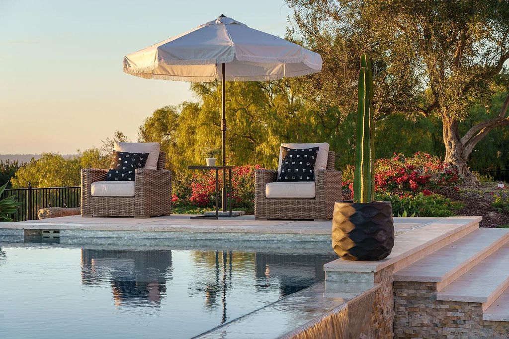 8069 Entrada De Luz East, San Diego, California is an exquisite estate located on in one of the most exclusive, gated golf communities in San Diego, boasts total privacy, large living areas, open through disappearing doors to multiple covered patios.