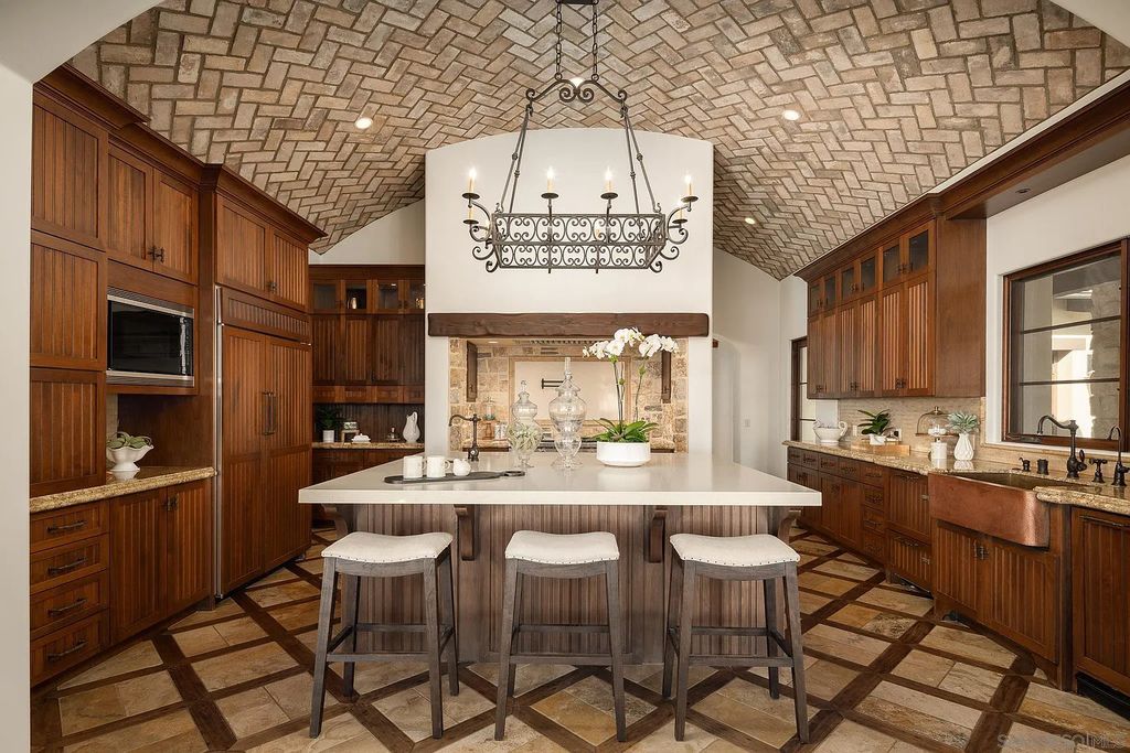 8069 Entrada De Luz East, San Diego, California is an exquisite estate located on in one of the most exclusive, gated golf communities in San Diego, boasts total privacy, large living areas, open through disappearing doors to multiple covered patios.