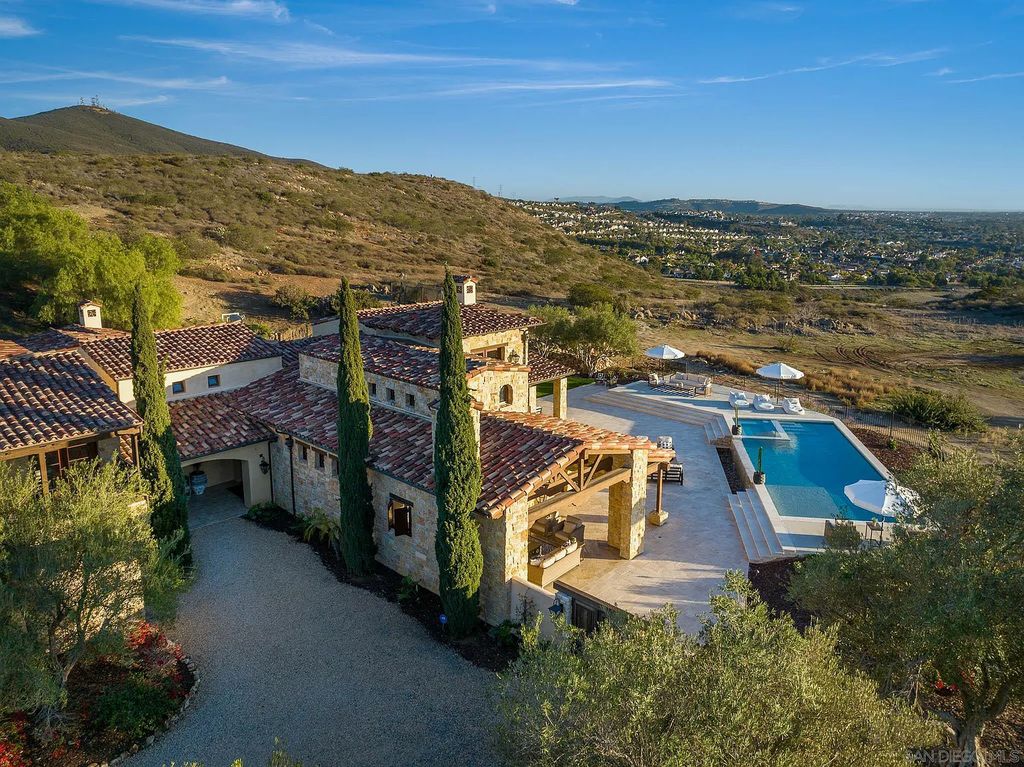 8069 Entrada De Luz East, San Diego, California is an exquisite estate located on in one of the most exclusive, gated golf communities in San Diego, boasts total privacy, large living areas, open through disappearing doors to multiple covered patios.
