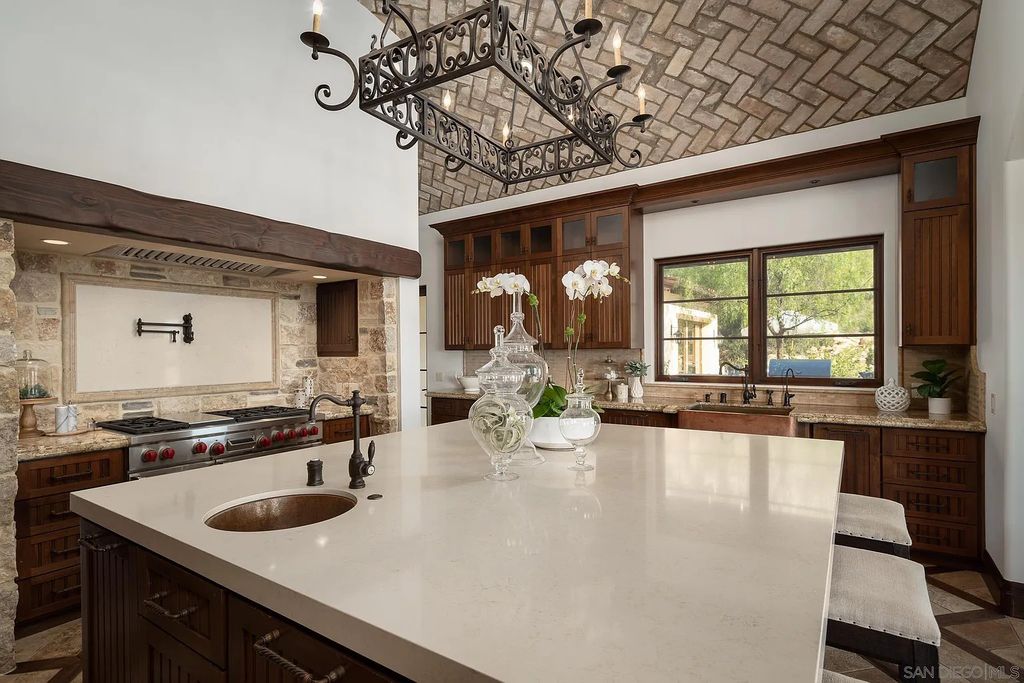 8069 Entrada De Luz East, San Diego, California is an exquisite estate located on in one of the most exclusive, gated golf communities in San Diego, boasts total privacy, large living areas, open through disappearing doors to multiple covered patios.