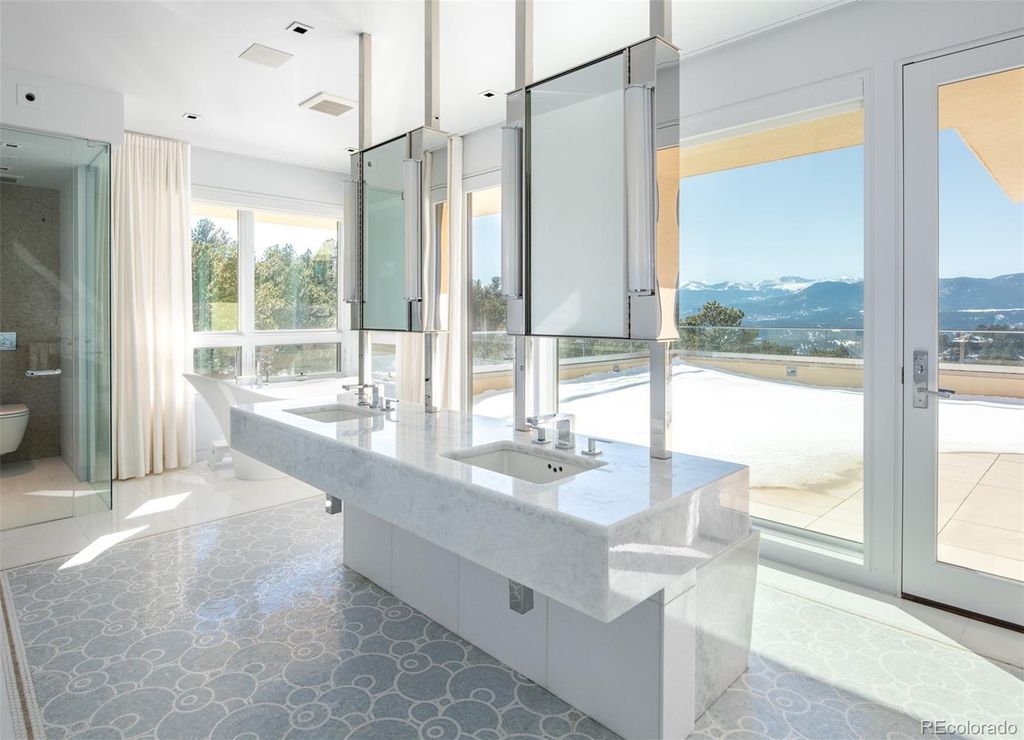1733 Montane Drive East, Golden, Colorado is a modern mountain estate perched on top of a Genesee peak were designed to accentuate the cascading Rocky Mountain views from nearly every window.