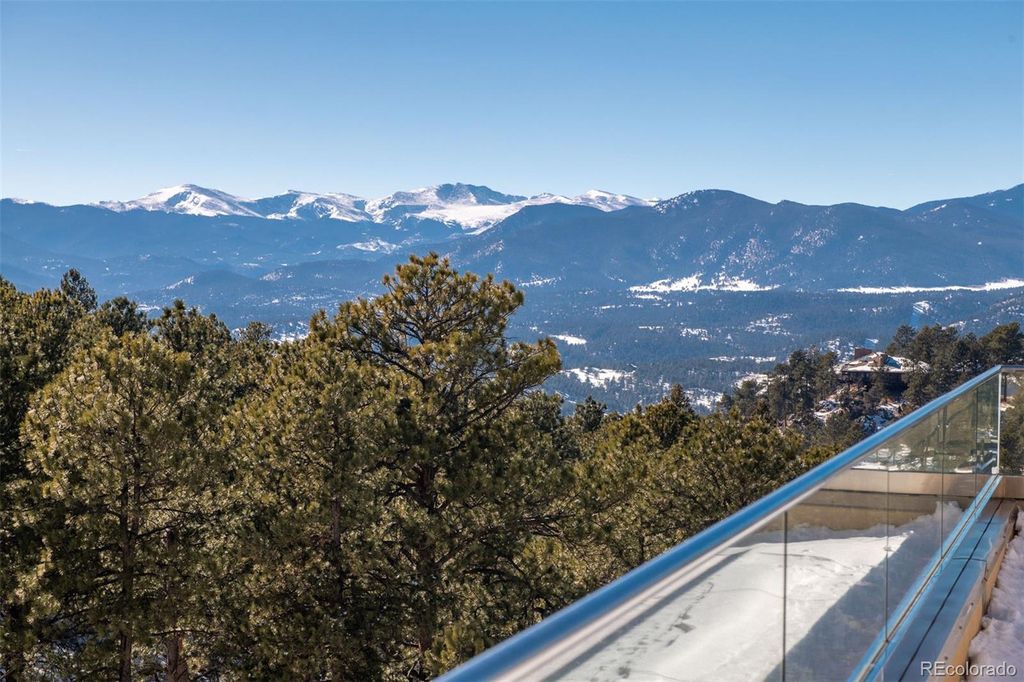 1733 Montane Drive East, Golden, Colorado is a modern mountain estate perched on top of a Genesee peak were designed to accentuate the cascading Rocky Mountain views from nearly every window.