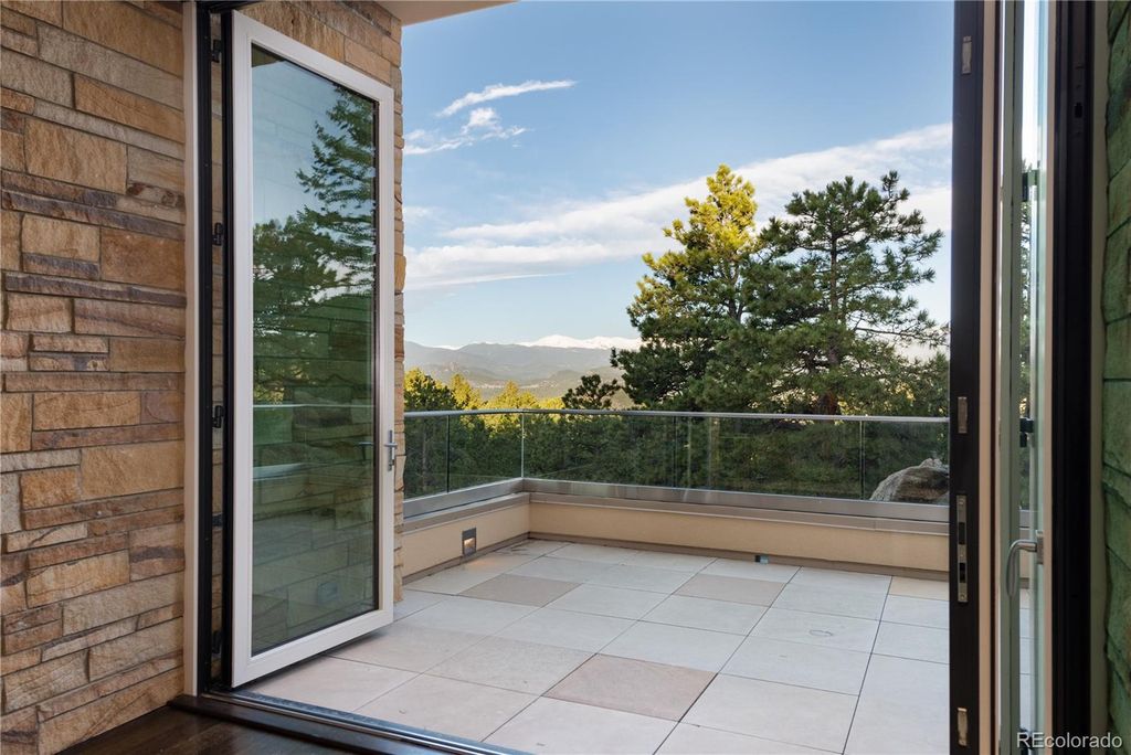 1733 Montane Drive East, Golden, Colorado is a modern mountain estate perched on top of a Genesee peak were designed to accentuate the cascading Rocky Mountain views from nearly every window.