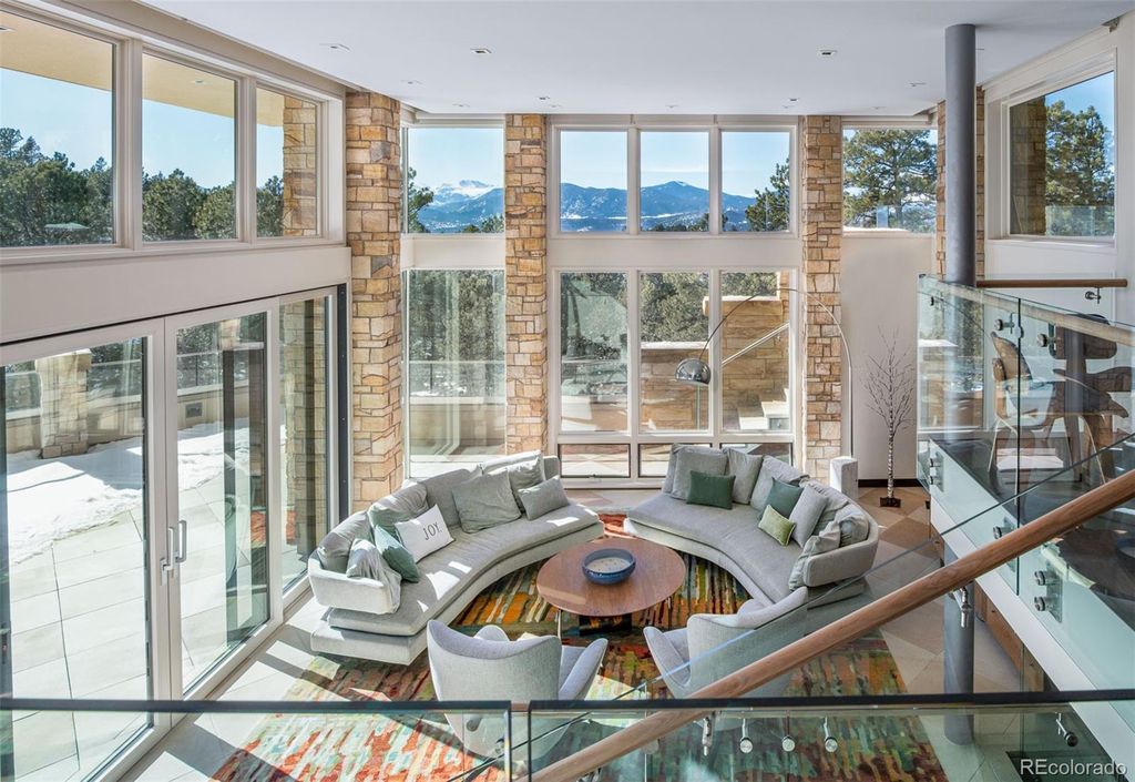 1733 Montane Drive East, Golden, Colorado is a modern mountain estate perched on top of a Genesee peak were designed to accentuate the cascading Rocky Mountain views from nearly every window.