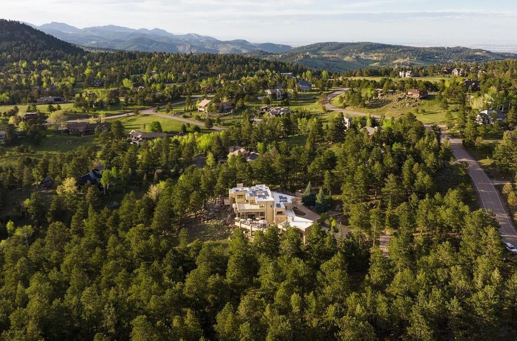 1733 Montane Drive East, Golden, Colorado is a modern mountain estate perched on top of a Genesee peak were designed to accentuate the cascading Rocky Mountain views from nearly every window.