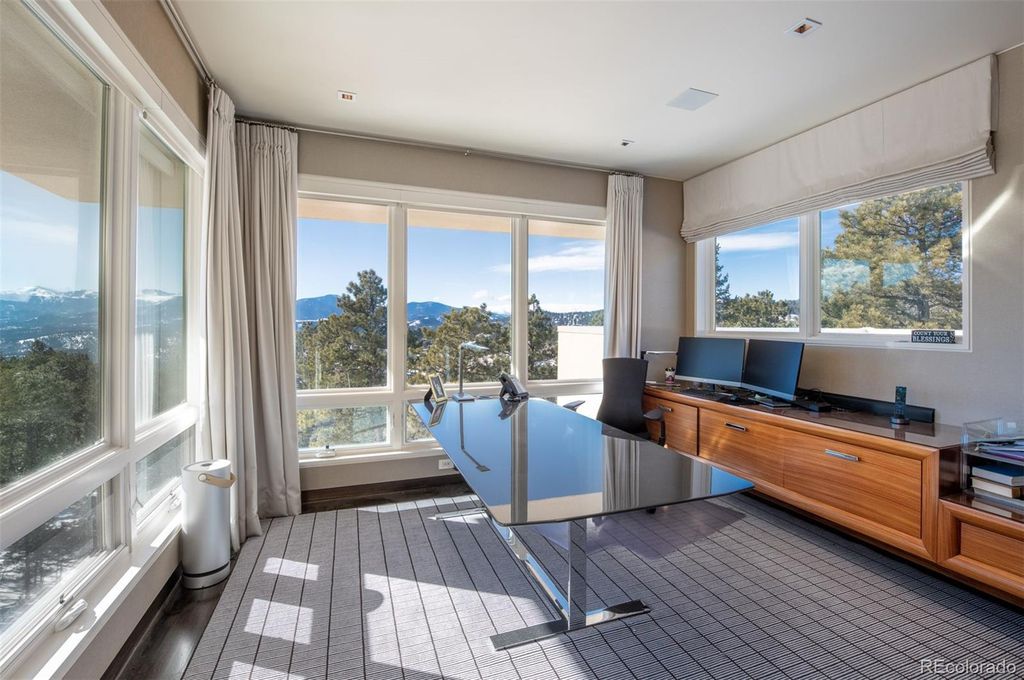 1733 Montane Drive East, Golden, Colorado is a modern mountain estate perched on top of a Genesee peak were designed to accentuate the cascading Rocky Mountain views from nearly every window.