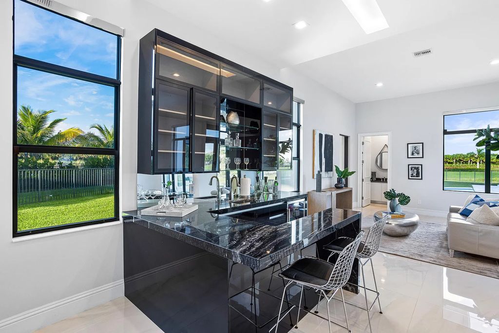 17055 Brulee Breeze Way, Boca Raton, Florida, is located in the heart of Boca Raton, Boca Bridges' centralized location, on an oversized 0.72 +- acre lot, which is the largest model offered at Boca Bridges. Integrating the sophisticated grandeur of resort-style living with family friendly amenities, this home offers a wide array of world-class amenities.