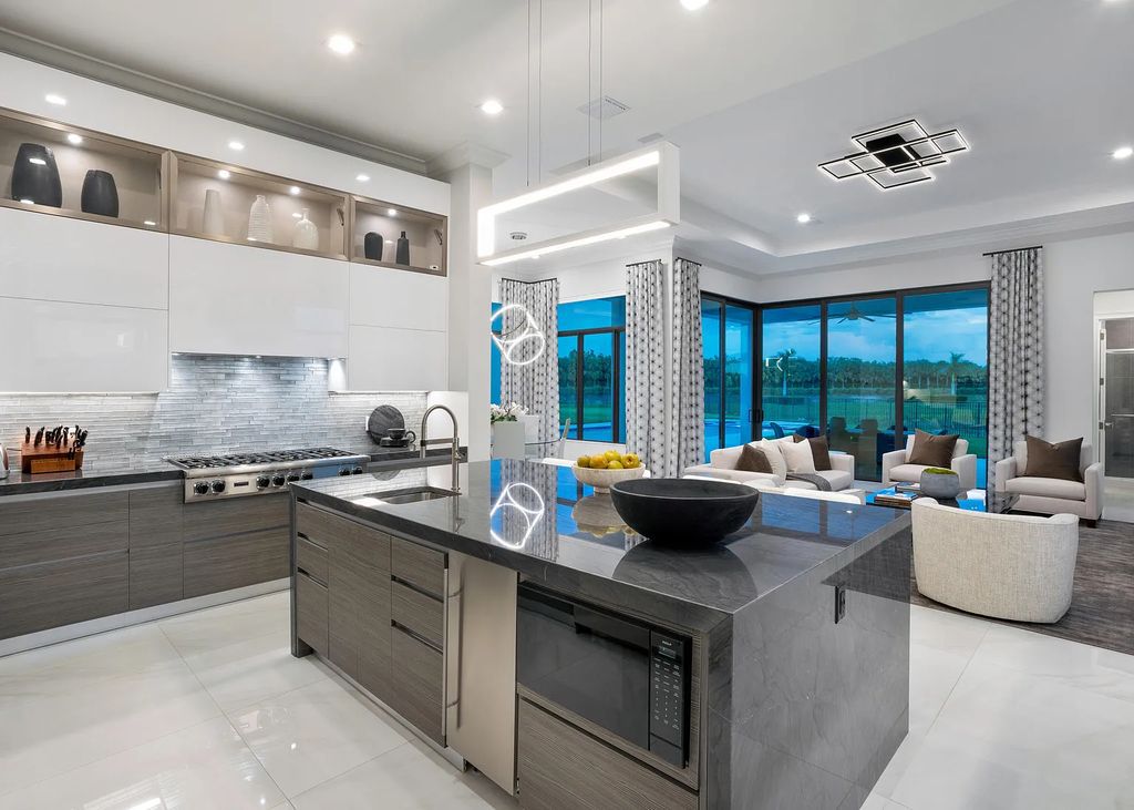 17055 Brulee Breeze Way, Boca Raton, Florida, is located in the heart of Boca Raton, Boca Bridges' centralized location, on an oversized 0.72 +- acre lot, which is the largest model offered at Boca Bridges. Integrating the sophisticated grandeur of resort-style living with family friendly amenities, this home offers a wide array of world-class amenities.
