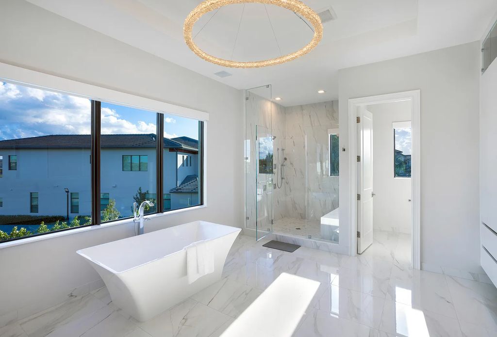 17055 Brulee Breeze Way, Boca Raton, Florida, is located in the heart of Boca Raton, Boca Bridges' centralized location, on an oversized 0.72 +- acre lot, which is the largest model offered at Boca Bridges. Integrating the sophisticated grandeur of resort-style living with family friendly amenities, this home offers a wide array of world-class amenities.