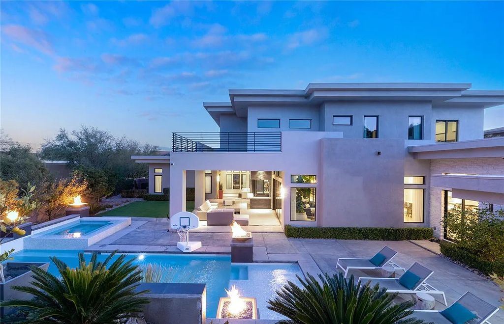 20 Skybird Court, Las Vegas, Nevada is a fully remodeled gem in the enclave of Redhawk behind the guard gates of The Ridges boasting a basketball area, pool with water slide and oversized wet deck, an indoor/outdoor bar, firepit, outdoor kitchen with ceiling mounted infrared heaters, and a wine cellar.