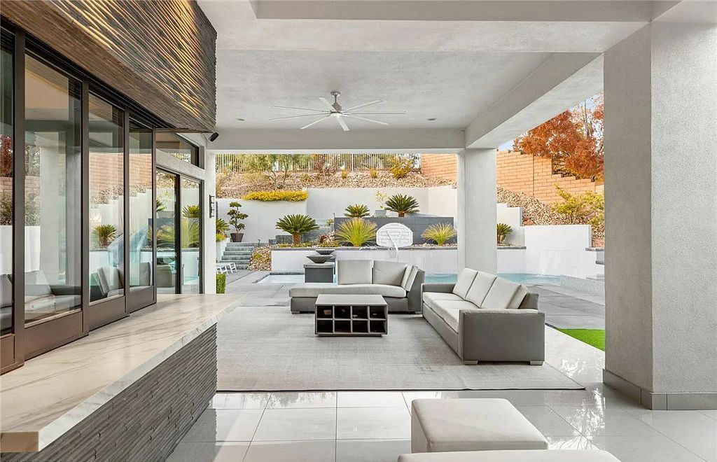 20 Skybird Court, Las Vegas, Nevada is a fully remodeled gem in the enclave of Redhawk behind the guard gates of The Ridges boasting a basketball area, pool with water slide and oversized wet deck, an indoor/outdoor bar, firepit, outdoor kitchen with ceiling mounted infrared heaters, and a wine cellar.