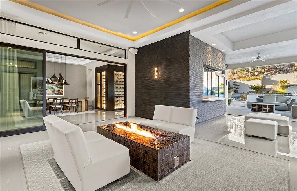 20 Skybird Court, Las Vegas, Nevada is a fully remodeled gem in the enclave of Redhawk behind the guard gates of The Ridges boasting a basketball area, pool with water slide and oversized wet deck, an indoor/outdoor bar, firepit, outdoor kitchen with ceiling mounted infrared heaters, and a wine cellar.