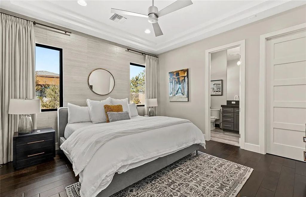 20 Skybird Court, Las Vegas, Nevada is a fully remodeled gem in the enclave of Redhawk behind the guard gates of The Ridges boasting a basketball area, pool with water slide and oversized wet deck, an indoor/outdoor bar, firepit, outdoor kitchen with ceiling mounted infrared heaters, and a wine cellar.