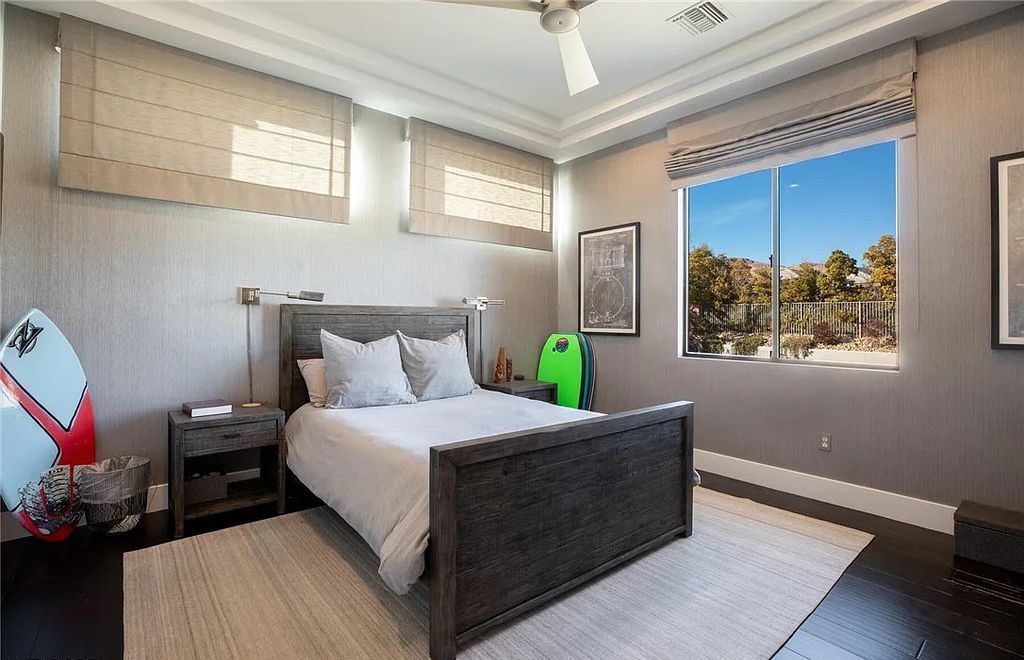 20 Skybird Court, Las Vegas, Nevada is a fully remodeled gem in the enclave of Redhawk behind the guard gates of The Ridges boasting a basketball area, pool with water slide and oversized wet deck, an indoor/outdoor bar, firepit, outdoor kitchen with ceiling mounted infrared heaters, and a wine cellar.