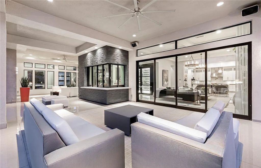 20 Skybird Court, Las Vegas, Nevada is a fully remodeled gem in the enclave of Redhawk behind the guard gates of The Ridges boasting a basketball area, pool with water slide and oversized wet deck, an indoor/outdoor bar, firepit, outdoor kitchen with ceiling mounted infrared heaters, and a wine cellar.